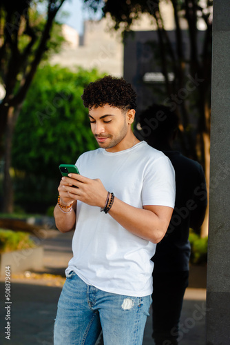 Young arab man texting in the street