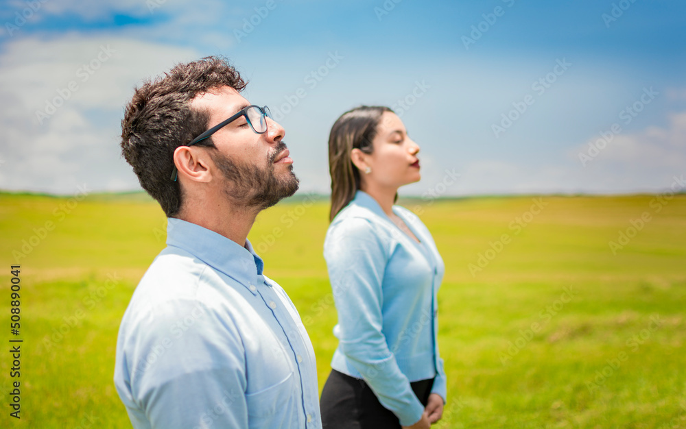 Obraz premium Concept of Young couple breathing fresh air with positive attitude, Two people breathing fresh air in the field, Young couple breathing fresh air in the field