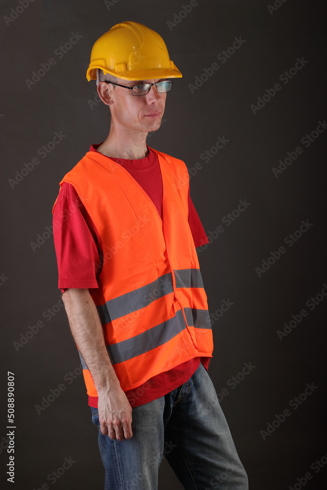 person in a protective helmet and reflective vest person in a protective helmet and reflective vest