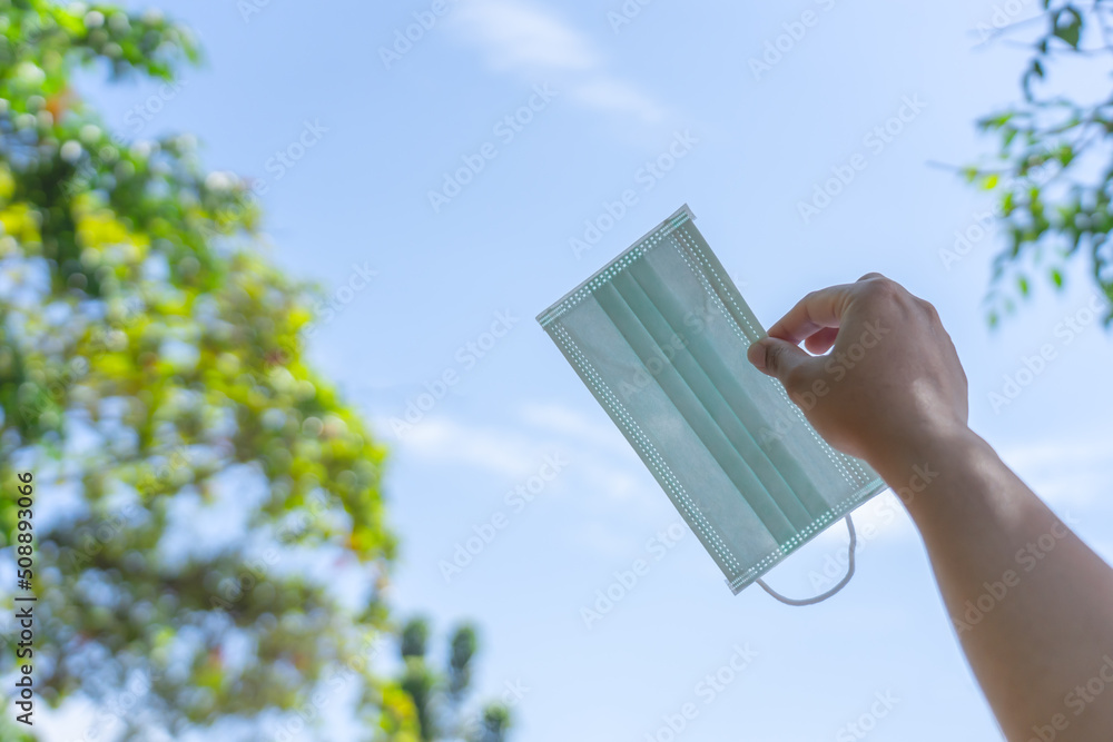 No more mask concept say goodbye to surgical mask after covid pandemic end. New normal life mask