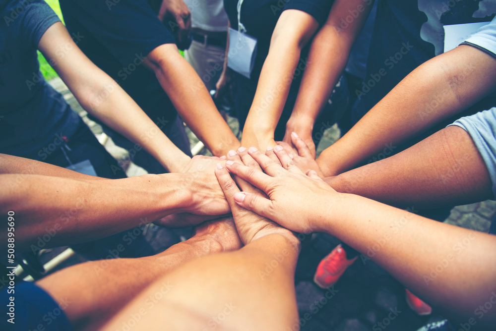 Teamwork Hands of spirit team working together outdoor. Unity strong handshake with people or agreement of feeling or happy diverse education action - obrazy, fototapety, plakaty 