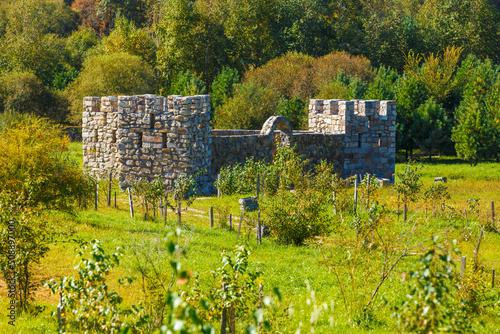 Fotografie Stone medieval fortress in a green field.