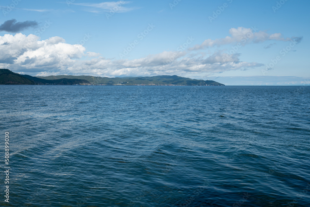 Beautiful view of Lake Baikal on a summer day. The clear calm surface of the lake