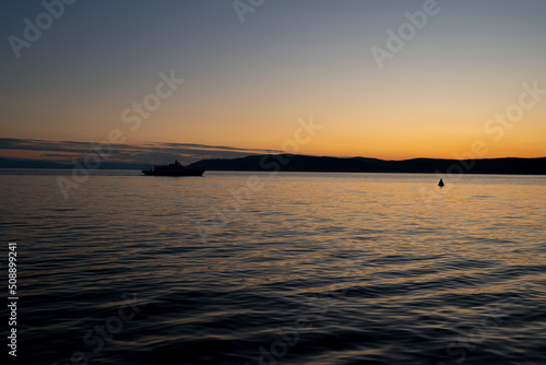 Colorful sunset over Lake Baikal. Boats and yachts with tourists are resting in the bay. © Иван Грабилин