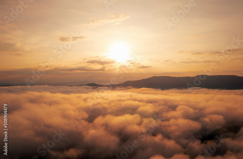 Aerial view Beautiful of morning scenery Golden light sunrise And the mist flows on high mountains forest. Pang Puai, Mae Moh, Lampang, Thailand. 