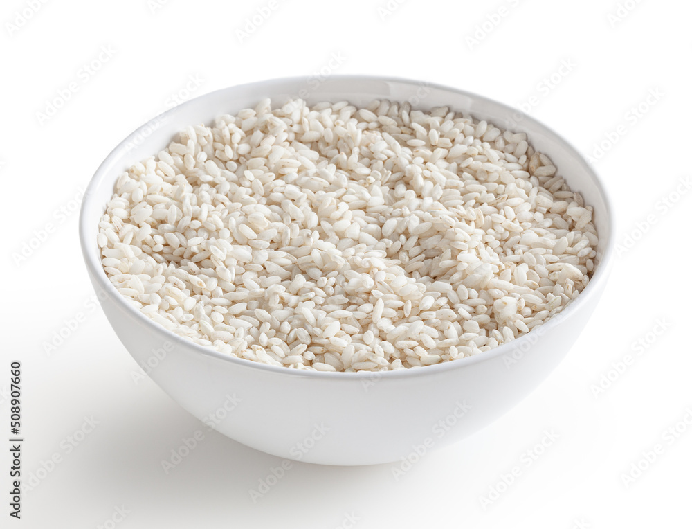 Uncooked arborio rice in white bowl isolated on white background with clipping path Uncooked arborio rice in white bowl isolated on white background with clipping path