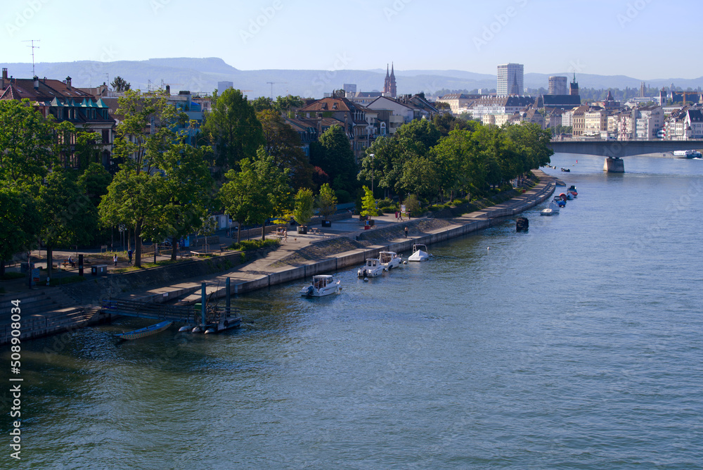 Obraz premium Aerial view over Rhine River with moored motor boats and people walking on boardwalk on a sunny spring day. Photo taken May 11th, 2022, Basel, Switzerland.