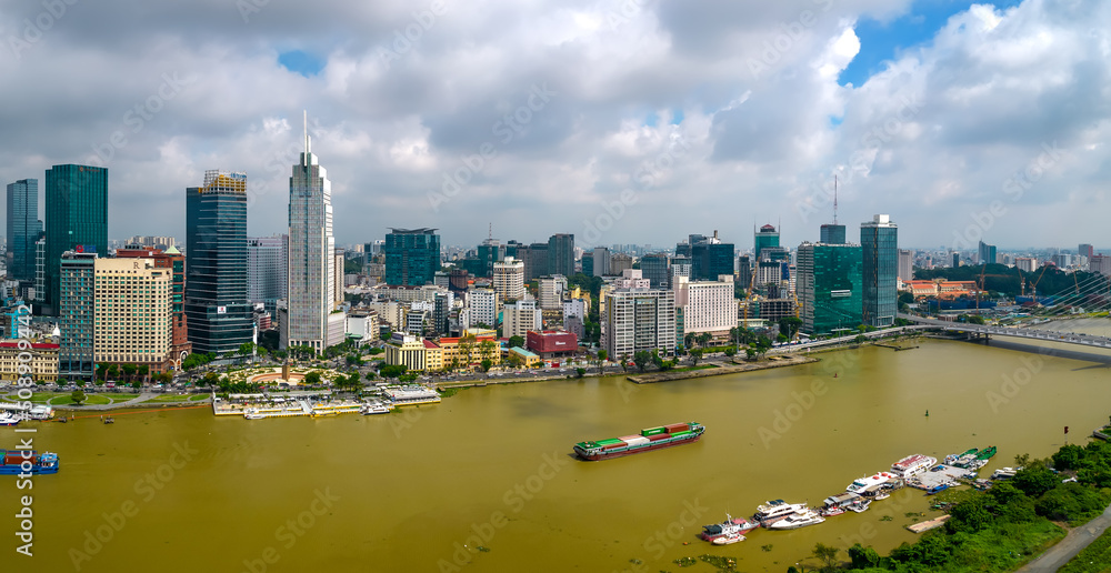 Fototapeta premium Top view aerial photo from flying drone of a Ho Chi Minh City with development buildings, transportation, energy power infrastructure. Financial and business centers in developed Vietnam