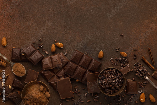 Chocolate variety on brown background copy space
