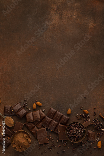 Chocolate variety on brown background copy space