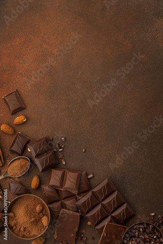 Chocolate variety on brown background copy space