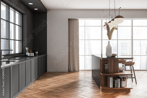 Kitchen interior with island and seats, deck and kitchenware, panoramic window © ImageFlow
