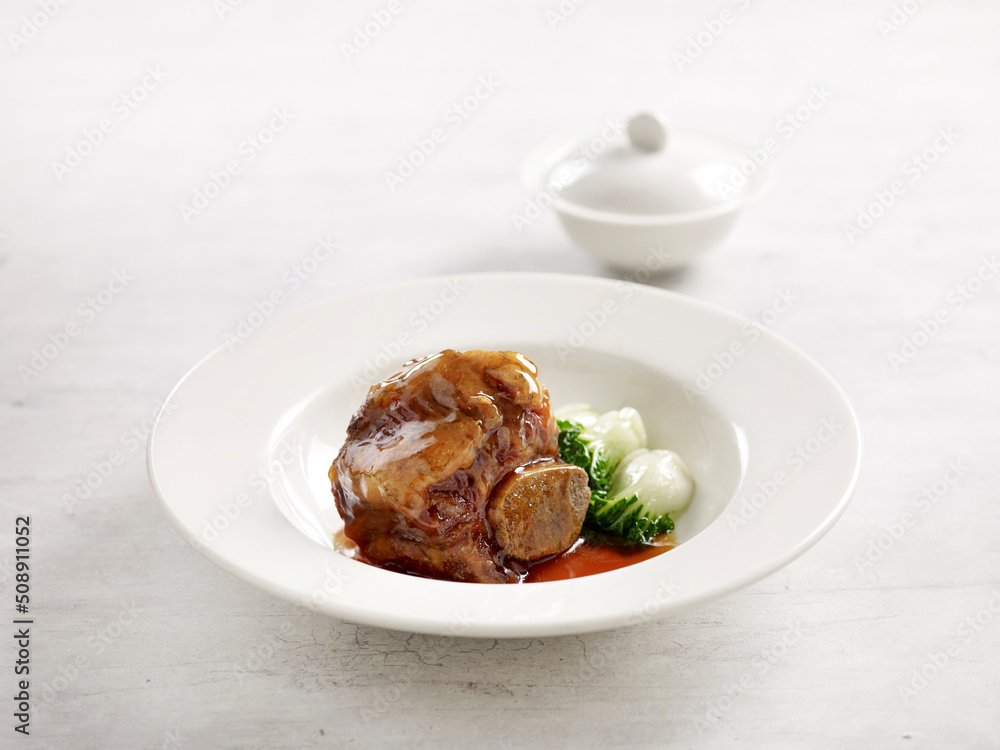 Braised US Angus Beef Short Rib in Brown Sauce served in a plate side view on grey marble background USA Food