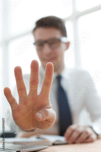 Young businessman man showing number four with fingers on hand