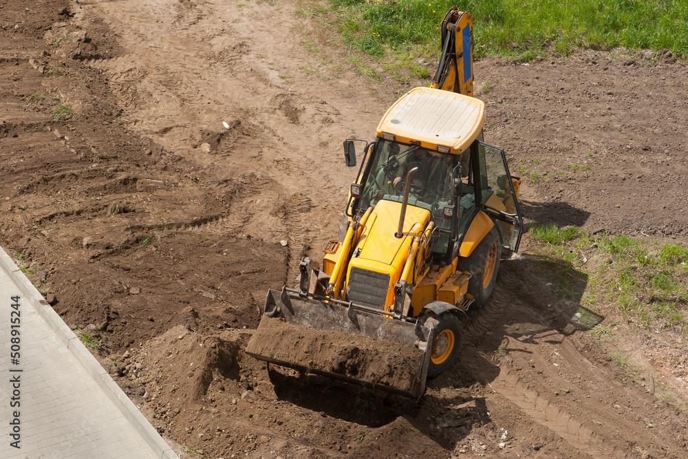 performing earthworks by a heavy machinery performing earthworks by a heavy machinery