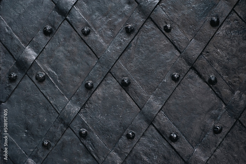 Old forged black metal door of the Boim chapel in Lvov. Vintage background closeup.