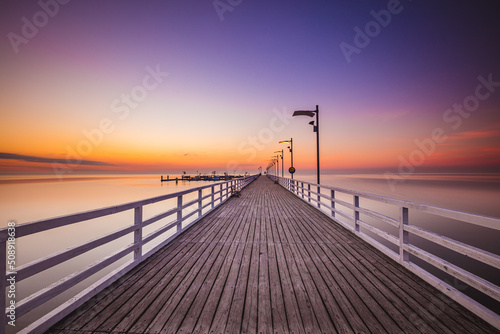 Fototapeta Naklejka Na Ścianę i Meble -  Amazing sunrise over the pier i Mechelinki. Baltic sea