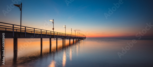 Amazing sunrise over the pier i Mechelinki. Baltic sea