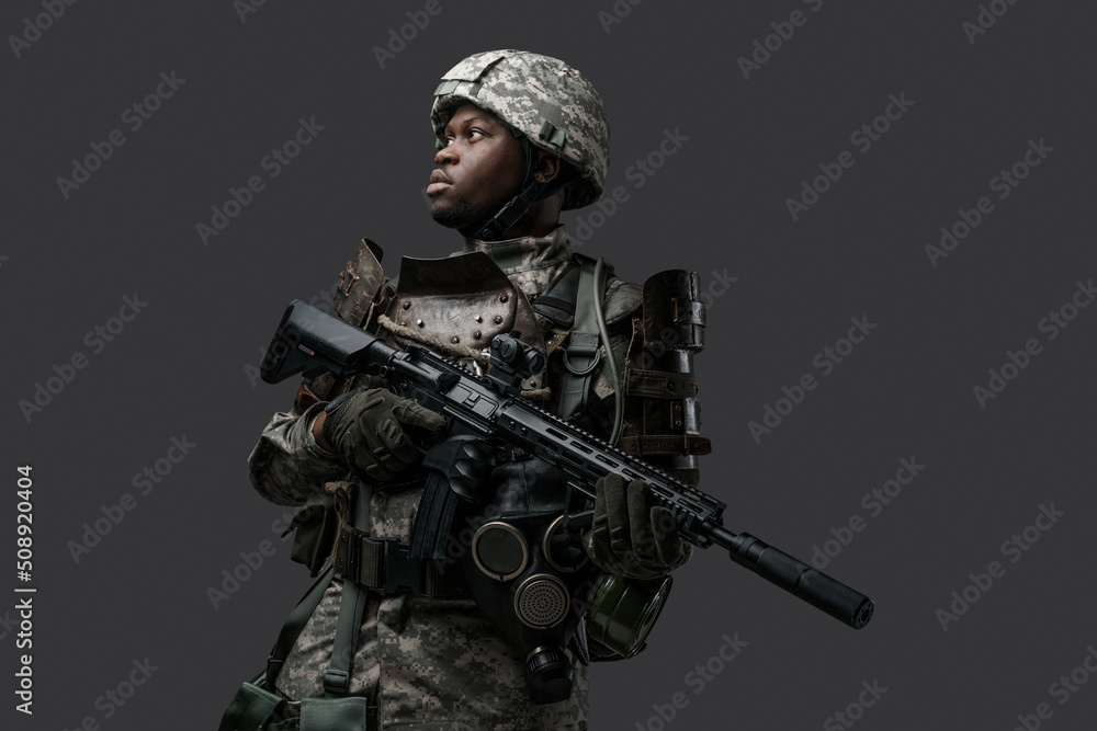 Shot of special forces soldier of african descent dressed in camouflage clothes holding rifle. Shot of special forces soldier of african descent dressed in camouflage clothes holding rifle.