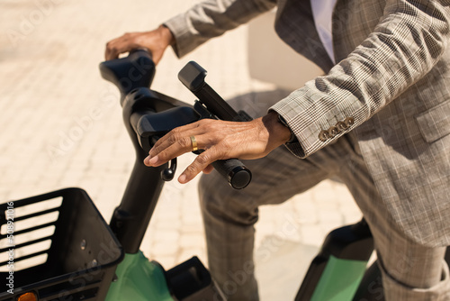 Close-up of African American man riding bicycle. Close-up of male hands holding modern bicycle. Active lifestyle concept