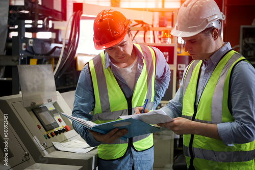 The Caucasian engineer talking and discussing in production line process after check and inspection the machine in factory, professional technician operating or work in manufacturing industrial
