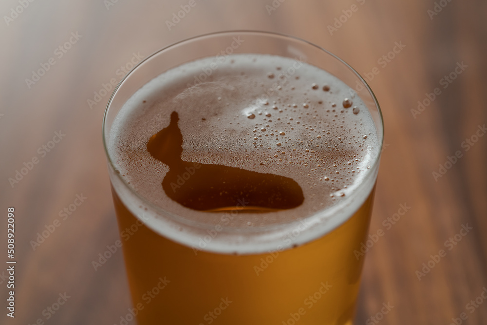 Organic apple cider in tumbler glass on wood table Organic apple cider in tumbler glass on wood table