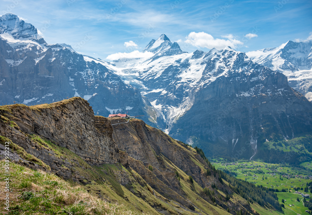Fototapeta premium Landscape of sky cliff walk metal bridge at First peak above Grindelwald village. Jungfrau region, Switzerland.