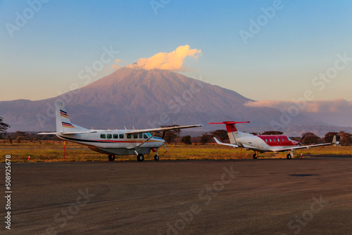 Small propeller airplanes on a background of Meru mountain in Arusha airport, Tanzania