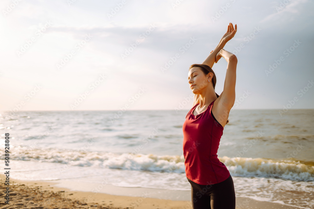 Young woman in sportswear doing yoga, fitness exerciseon the beach. Sport, Active life. Young woman in sportswear doing yoga, fitness exerciseon the beach. Sport, Active life.