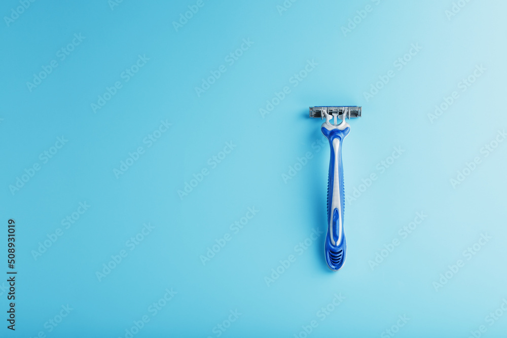 Shaving machine for the face on a blue background top view free space Shaving machine for the face on a blue background top view free space