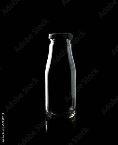Empty bottle isolated on black background