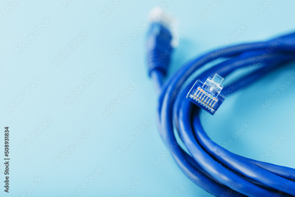 Blue UTP Internet Cable Isolated on a blue background Ethernet Cord Blue UTP Internet Cable Isolated on a blue background Ethernet Cord