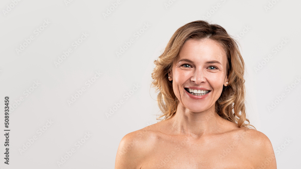 Natural Beauty. Portrait Of Attractive Smiling Middle Aged Woman With Naked Shoulders Natural Beauty. Portrait Of Attractive Smiling Middle Aged Woman With Naked Shoulders