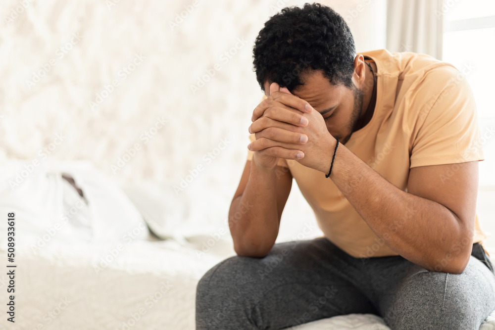 Unrecognizable Arabic Man Covering Face Suffering From Depression Sitting Indoor Unrecognizable Arabic Man Covering Face Suffering From Depression Sitting Indoor
