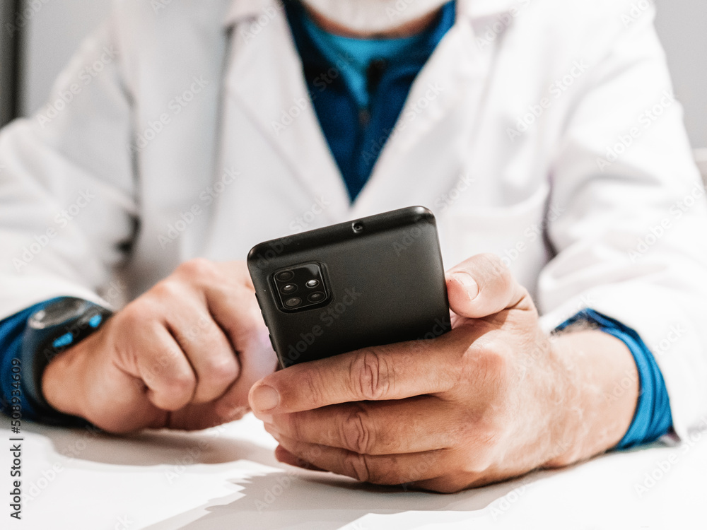 close up of a unrecognizable senior man's hands holding a telephone close up of a unrecognizable senior man's hands holding a telephone