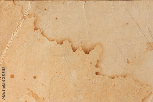 Old yellowed paper with stains from water