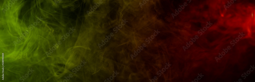 Obraz premium Red yellow green smoke on a black background.