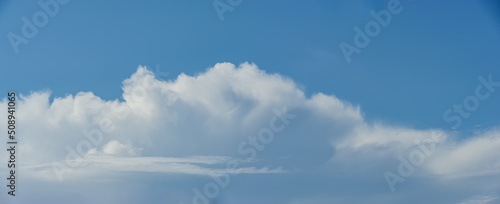 Fotografie Cumulus and stratus clouds against the blue sky.