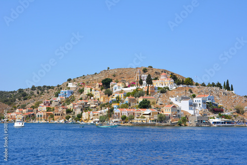 greek island Symi with colored houses, view on waterfront from boat