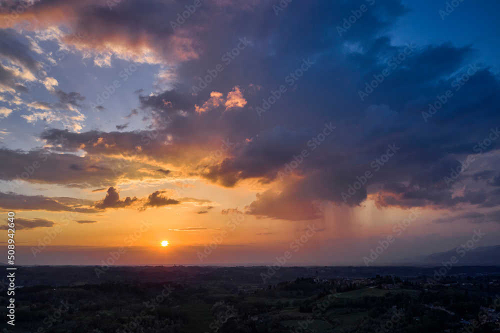 Fototapeta premium Scenic sunset over the vineyard in Tuscan hills