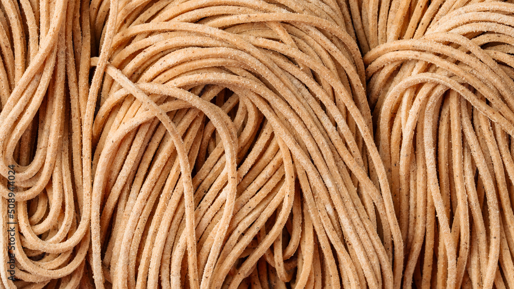 Closeup on dry raw buckwheat noodles texture background Closeup on dry raw buckwheat noodles texture background