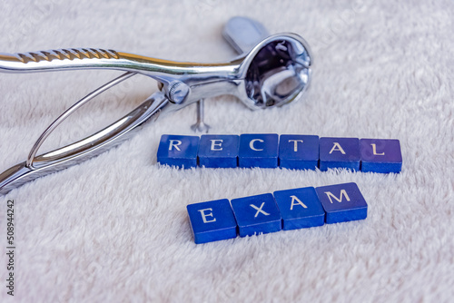 rectoscope with the words rectal exam on a white blanket