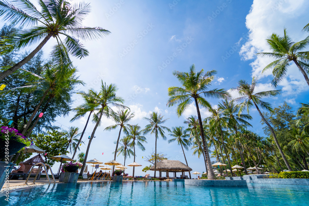 Amazing tropical paradise beach with swimming pools and coconut palms