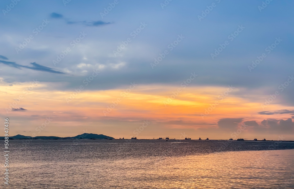 The red clouds at sunset look beautiful in the evening. ocean landscape The red clouds at sunset look beautiful in the evening. ocean landscape