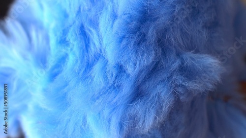 Blue faux fur. long pile. Children's toy. Piece of clothing. animal protection. Substitute for natural fur. fabric production. close-up.