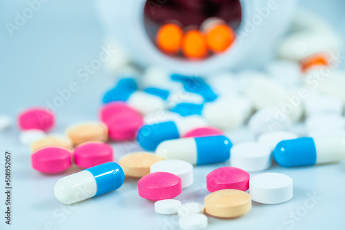 Macro shot of various colored pills on a white background, close-up health care and medical concept © alis