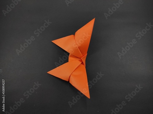 Paper butterfly in orange color isolated on black background  Not Focus