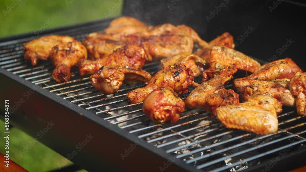 Delicious chicken pieces frying on barbecue grill Delicious chicken pieces frying on barbecue grill