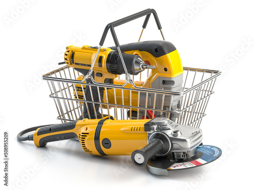 Shopping basket with elecric tools and construction equipment angle grinder, electric drill and jigsaw isolated on white. Selling and buying online. photo