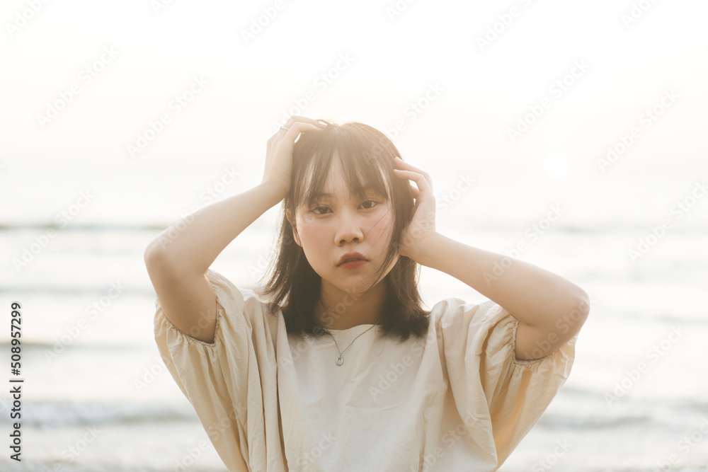 Portrait of southeast asian woman face eye looking at camera at the beach with sunlight Portrait of southeast asian woman face eye looking at camera at the beach with sunlight